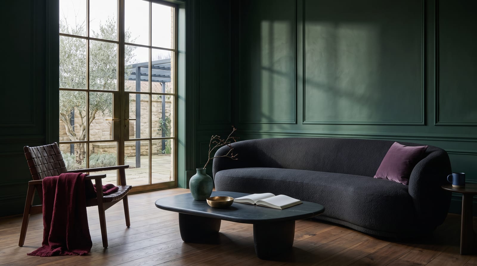 A deep winter environment: a lived-in interior rendered in cool near-blacks and jewel tones, hard evening light through tall glass, dark lacquer and a single emerald velvet chair, no people in frame, the kind of room the palette belongs in.