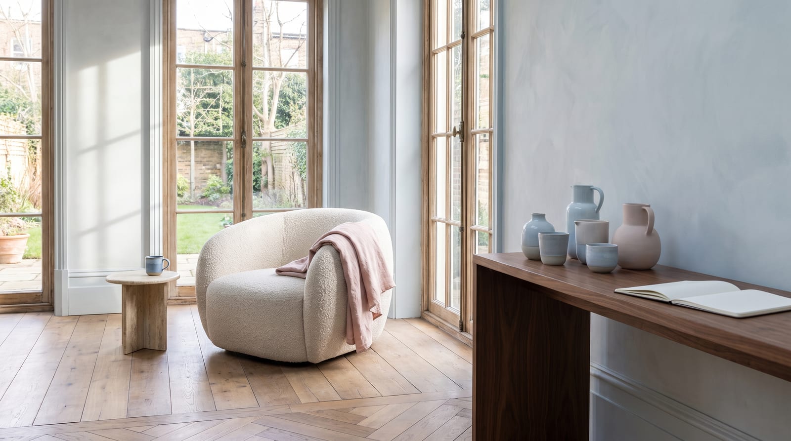 A light summer environment: a lived-in interior rendered entirely in the palette's cool light tones, flat north-facing daylight through sheer curtains, no people in frame, the kind of room the palette belongs in.