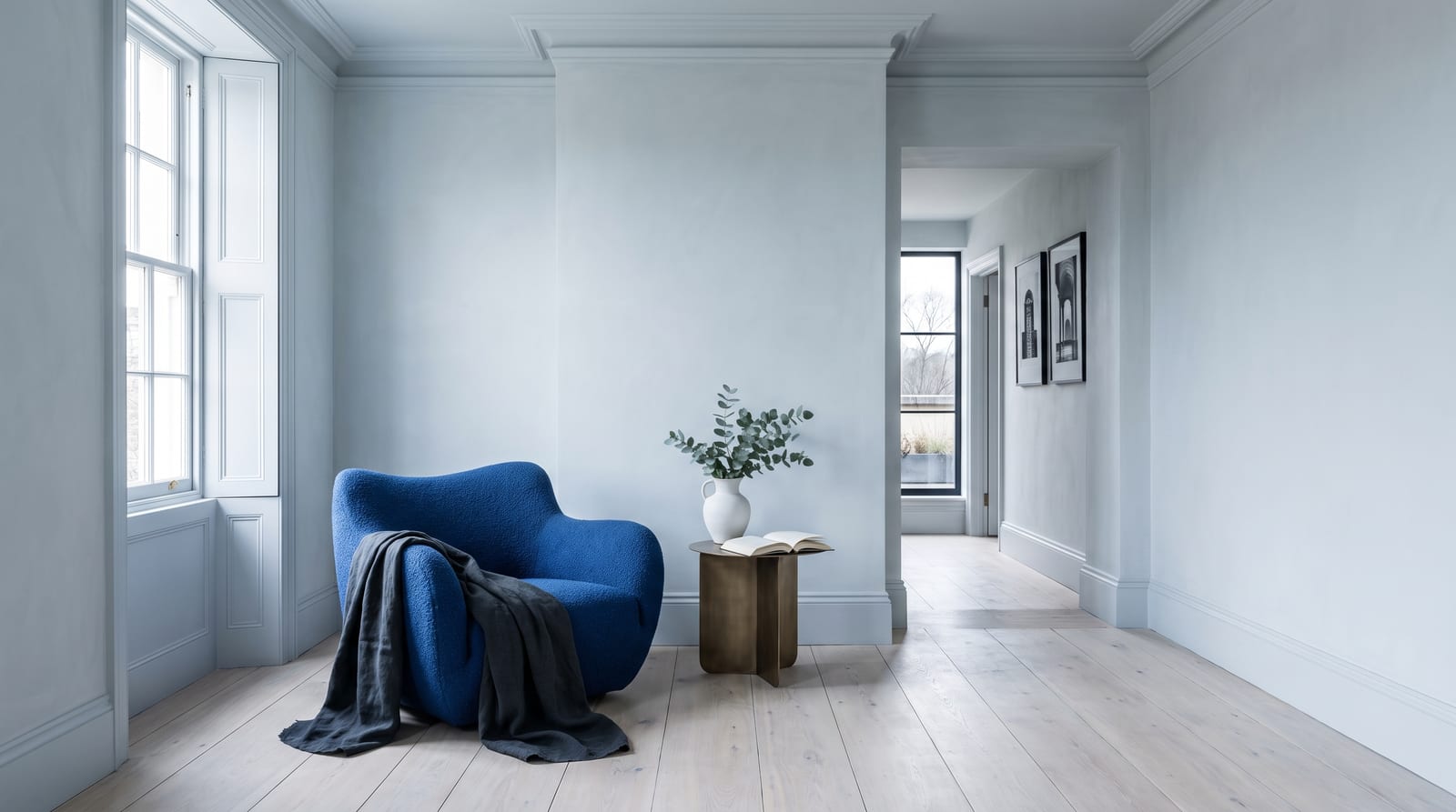 A cool winter environment: a clean, high-contrast interior rendered in the palette's cool tones, true-black and pure-white surfaces with a single emerald or cobalt accent, hard daylight through tall windows, no people in frame, the kind of room the palette belongs in.