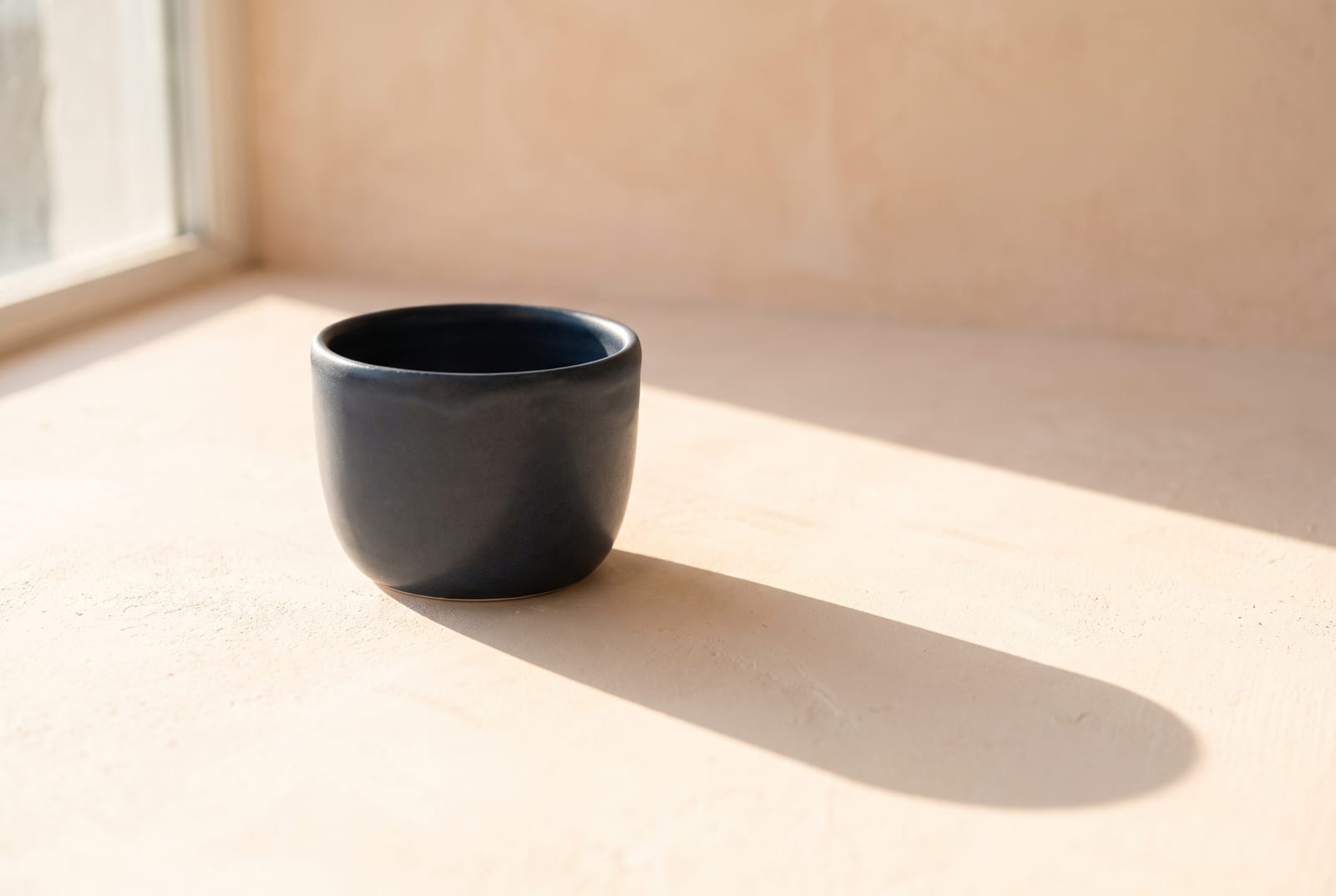 A light spring single-object study: one palette-hex subject, a folded coral knit or a small peach-glazed vessel, on pale plaster with generous negative space, intentionally quiet after the 24-swatch color block.