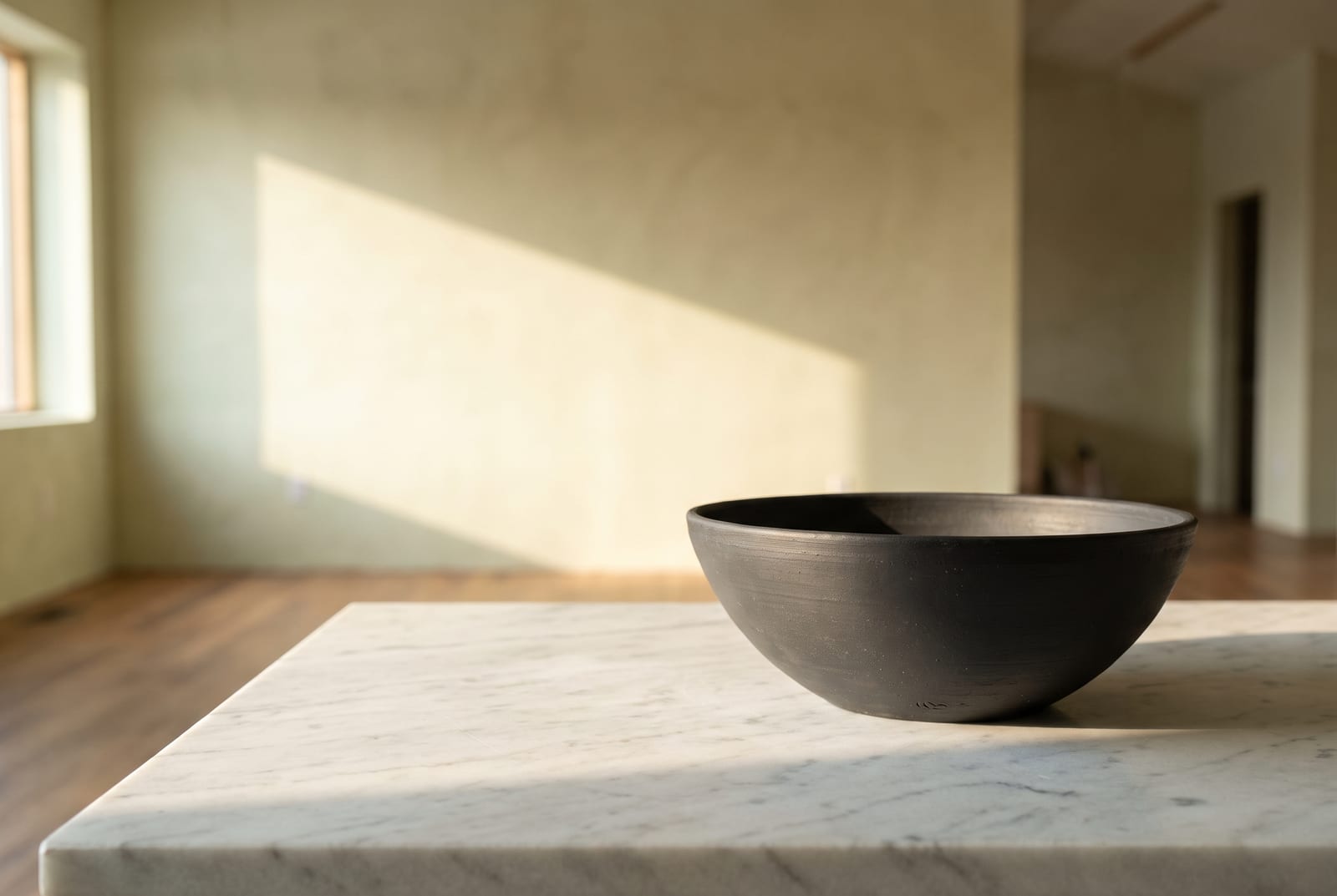 A cool winter single-object study: one palette-hex subject, a folded cobalt knit or a true-black lacquered object, on pure-white plaster with generous negative space, intentionally sharp after the 24-swatch color block.